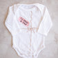 Embroidered "gift" onesie