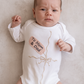 Embroidered "gift" onesie